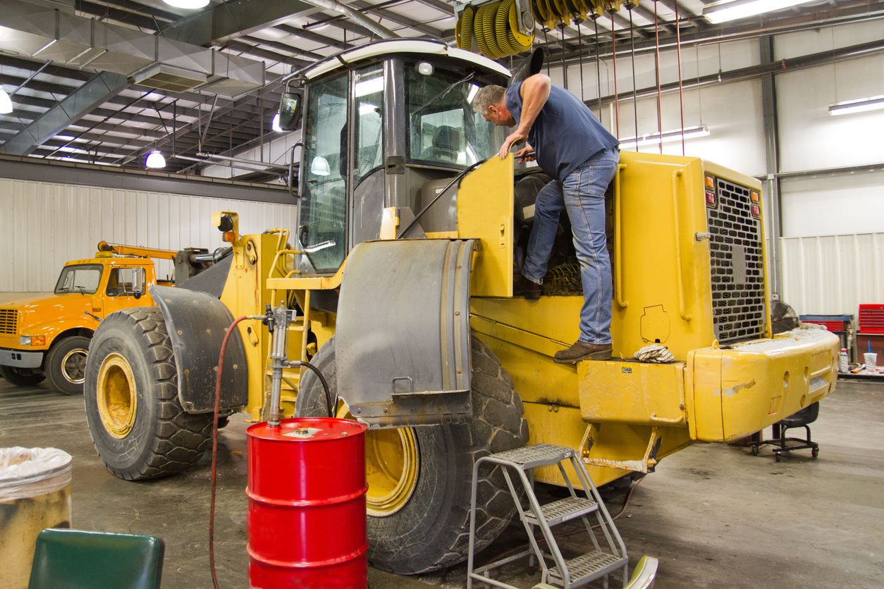Heavy equipment requires a mechanic to climb on the machine to check oils, filters and make repairs. A mechanic adds hydraulic fluid in a modern shop, much easier than a consruction site. The barrel contains hydraulic fluid and has an air operated pump. Fender is hinged to allow access to engine compartment.